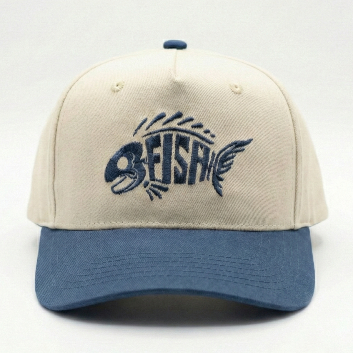 Beige and navy cap with FISH logo on a white background